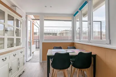 a dining room with a table and some windows at San Paolo - 10 min from Metro and 30 mq Terrace in Rome