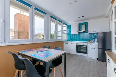 a kitchen with a table and chairs in a room at San Paolo - 10 min from Metro and 30 mq Terrace in Rome