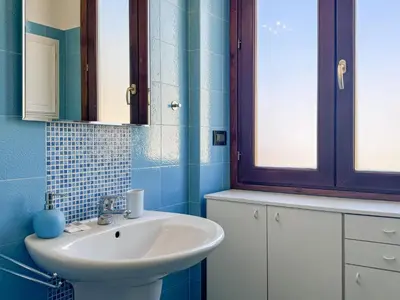 a bathroom with a sink and a mirror at Escher's Penthouse on Nomentana in Rome