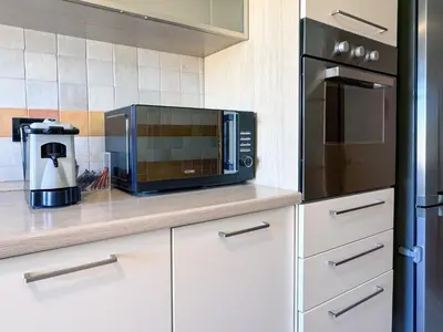 a kitchen with a microwave and a coffee maker at Escher's Penthouse on Nomentana in Rome