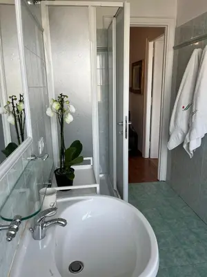 a bathroom with a white sink and a mirror at Tiburtina Sky Loft in Rome