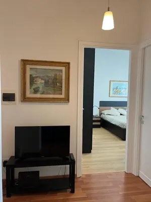 a living room with a television and a bedroom at Tiburtina Sky Loft in Rome