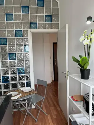 a dining room with a table and a wall of glass tiles at Tiburtina Sky Loft in Rome