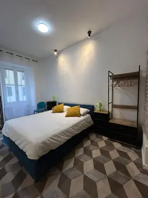 a bedroom with a large bed with yellow pillows at Lilla a Testaccio in Rome