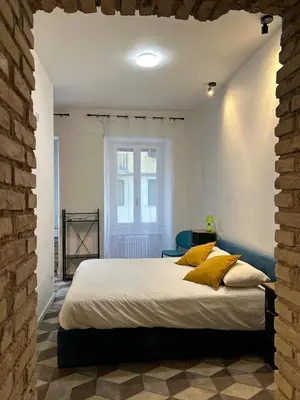 a bedroom with a large white bed with yellow pillows at Lilla a Testaccio in Rome