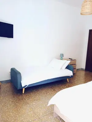 a bedroom with a bed and a tv on a wall at DOMUS REMO Room #1 in Rome