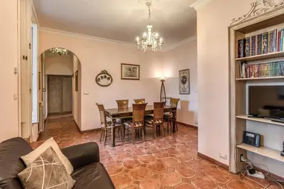 a dining room and living room with a table and chairs at Casa Vacanze San Giovanni in Rome