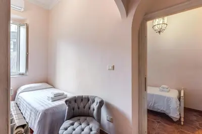 a bedroom with a bed and a chair in it at Casa Vacanze San Giovanni in Rome