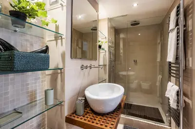 a bathroom with a sink and a shower at Your nest with wooden ceilings in Monti in Rome