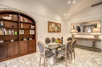 a dining room with a glass table and chairs at Casa Vacanze Crispi in Rome