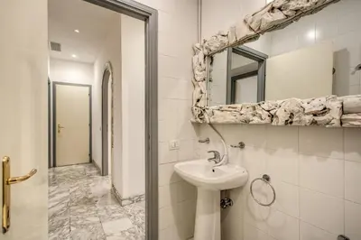 a bathroom with a sink and a mirror at Casa Vacanze Crispi in Rome