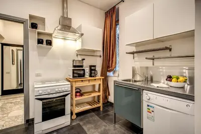 a kitchen with a sink and a stove at Casa Vacanze Crispi in Rome