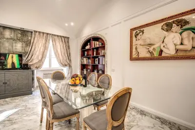 a dining room with a glass table and chairs at Casa Vacanze Crispi in Rome