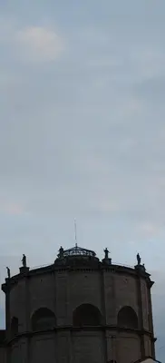 a tall brick building with a sky in the background at Front Vatican museum in Rome