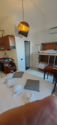a room with three beds with towels on them at Front Vatican museum in Rome