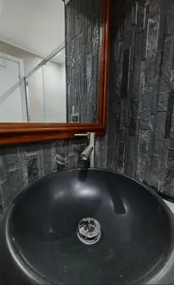 a black sink in a bathroom with a mirror at Front Vatican museum in Rome