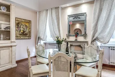 a dining room with a glass table and chairs at Casa Vacanze Crispi little 1 in Rome
