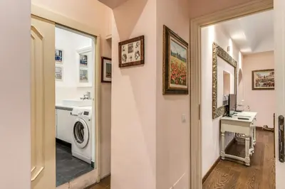 a bathroom with a washer and dryer and a sink at Casa Vacanze Crispi little 1 in Rome