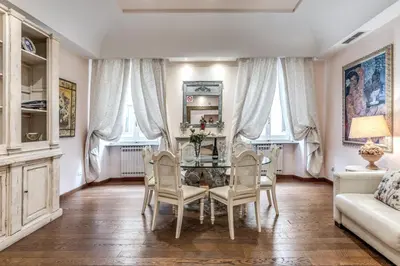 a dining room with a glass table and chairs at Casa Vacanze Crispi little 1 in Rome