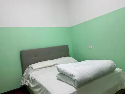 a bed with two pillows on it in a room at Bellaroma Astréa apartment in Rome