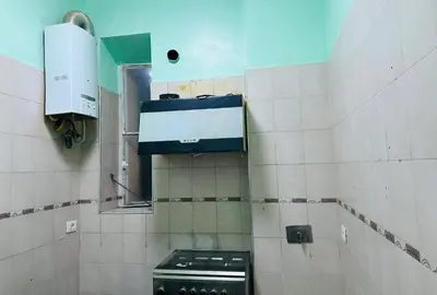 a kitchen with a stove in a tiled bathroom at Bellaroma Astréa apartment in Rome