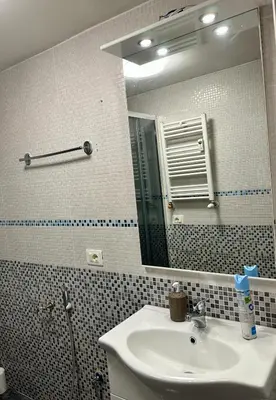 a bathroom with a sink and a mirror at Bellaroma Astréa apartment in Rome