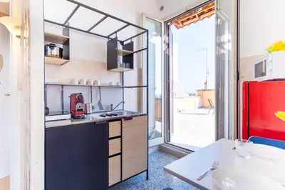 a kitchen with a sink and a red refrigerator at Elegantis La Dolce Vista Apartment with private terrace and fantastic View in Rome