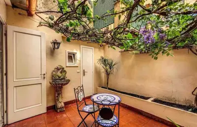 a room with a table and a chair next to a door at Casa Vacanze Crispi little 2 in Rome