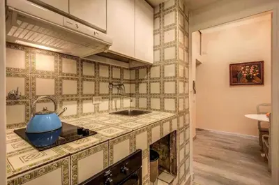 a kitchen with a blue pot on top of a stove at Casa Vacanze Crispi little 2 in Rome