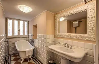 a white bathroom with a sink and a mirror at Casa Vacanze Crispi little 2 in Rome