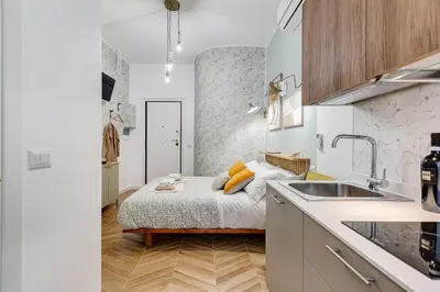 a small bedroom with a bed and a sink at BDC - Love nest! Small but cozy in Rome