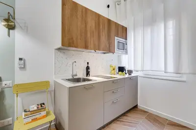 a white kitchen with a sink and a microwave at BDC - Love nest! Small but cozy in Rome
