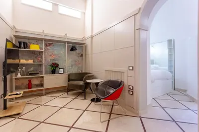 a room with a bed and a table and a chair at Oliviero - Piazza Navona Suite in Rome