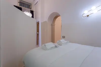 a white bed with two towels on top of it at Oliviero - Piazza Navona Suite in Rome