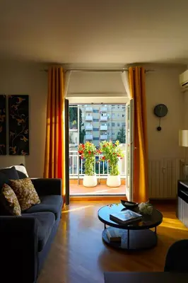 a living room with a couch and a table and a window at Clivo Vaticano Rooftop in Rome