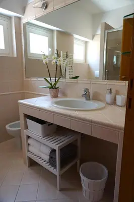 a bathroom with a sink and a mirror at Clivo Vaticano Rooftop in Rome