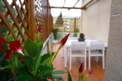 a dining room with a table and white chairs at Clivo Vaticano Rooftop in Rome