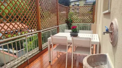 a table and chairs on a balcony with a fence at Clivo Vaticano Rooftop in Rome
