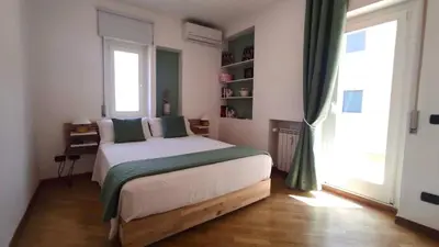 a bedroom with a bed and a large window at Clivo Vaticano Rooftop in Rome