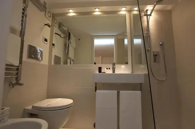a bathroom with a sink and a toilet and a mirror at LHP Suite Roma Piazza del Popolo in Rome