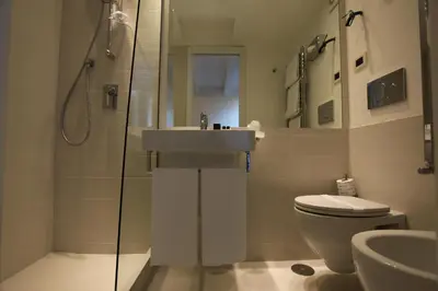 a bathroom with a sink and a toilet and a shower at LHP Suite Roma Piazza del Popolo in Rome