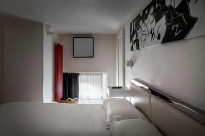 a living room with a couch and a bed at LHP Suite Roma Piazza del Popolo in Rome