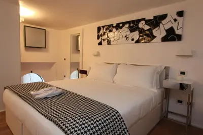 a bedroom with a bed with a black and white blanket at LHP Suite Roma Piazza del Popolo in Rome