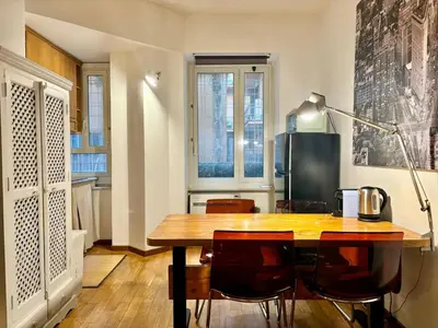 a dining room with a wooden table and chairs at RomeAsYouLike - Colonna Apartment N 50 in Rome
