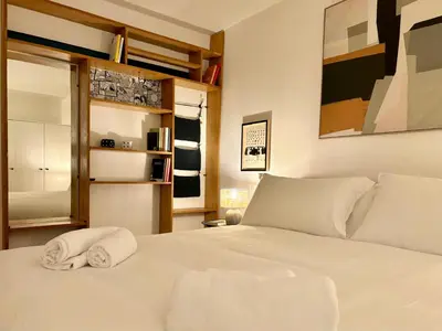 a bedroom with a white bed with towels on it at RomeAsYouLike - Colonna Apartment N 50 in Rome