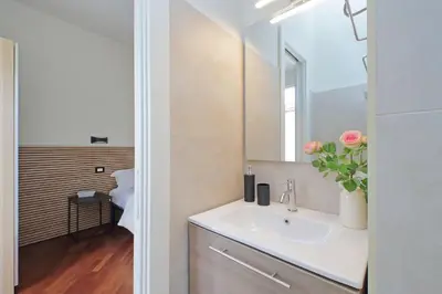 a bathroom with a sink and a mirror at Vatican apartment Leone IV - MrLucas in Rome