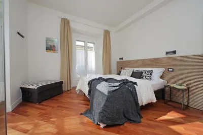 a bedroom with a large bed and a wooden floor at Vatican apartment Leone IV - MrLucas in Rome
