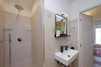 a bathroom with a sink and a shower at Vatican apartment Leone IV - MrLucas in Rome