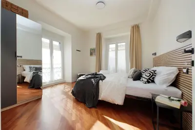 a bedroom with a bed and a large mirror at Vatican apartment Leone IV - MrLucas in Rome