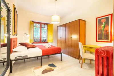 a bedroom with a bed and a desk at La Piccola Retró , urban color and comfort in Rome